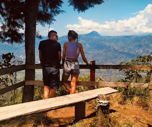 Two people talking and admiring the mountain landscape in Colombia