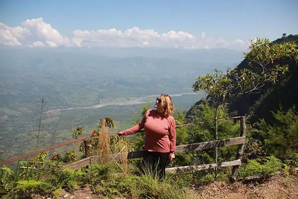 Woman enjoying a Riverside Ecoliving retreat with mountain views in Colombia
