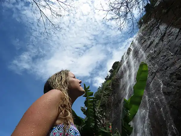 Traveler admiring a waterfall in Colombia during a Riverside Ecoliving nature experience