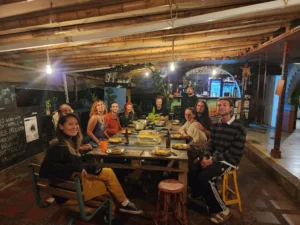 Group of people sharing a dinner together at Riverside Ecoliving partner in Guatapé