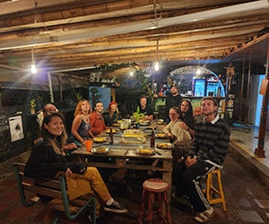 Group dinner at Riverside’s Guatapé destination, guests sharing food and conversation in a warm, communal setting