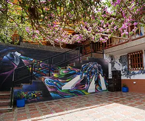 Entrance to Riverside’s Guatapé destination with a colorful mural on the wall.
